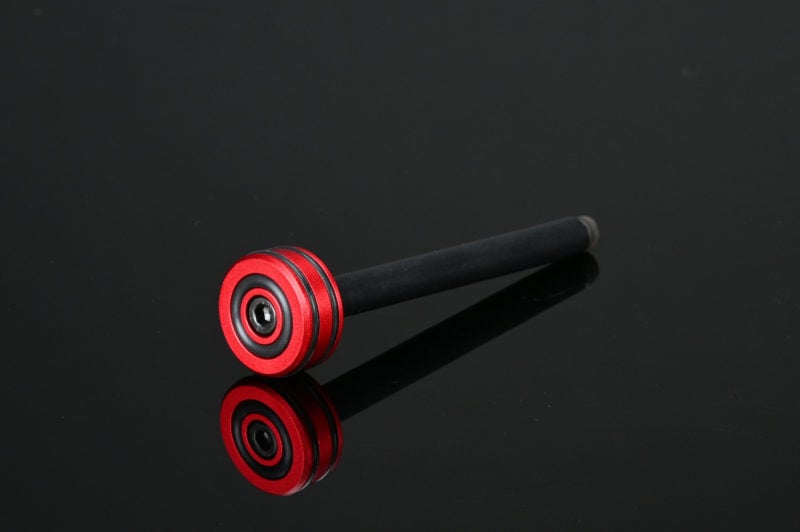 A black and red SRS Teflon spring guide for a pull bolt, with a visible Japanese thrust bearing base.